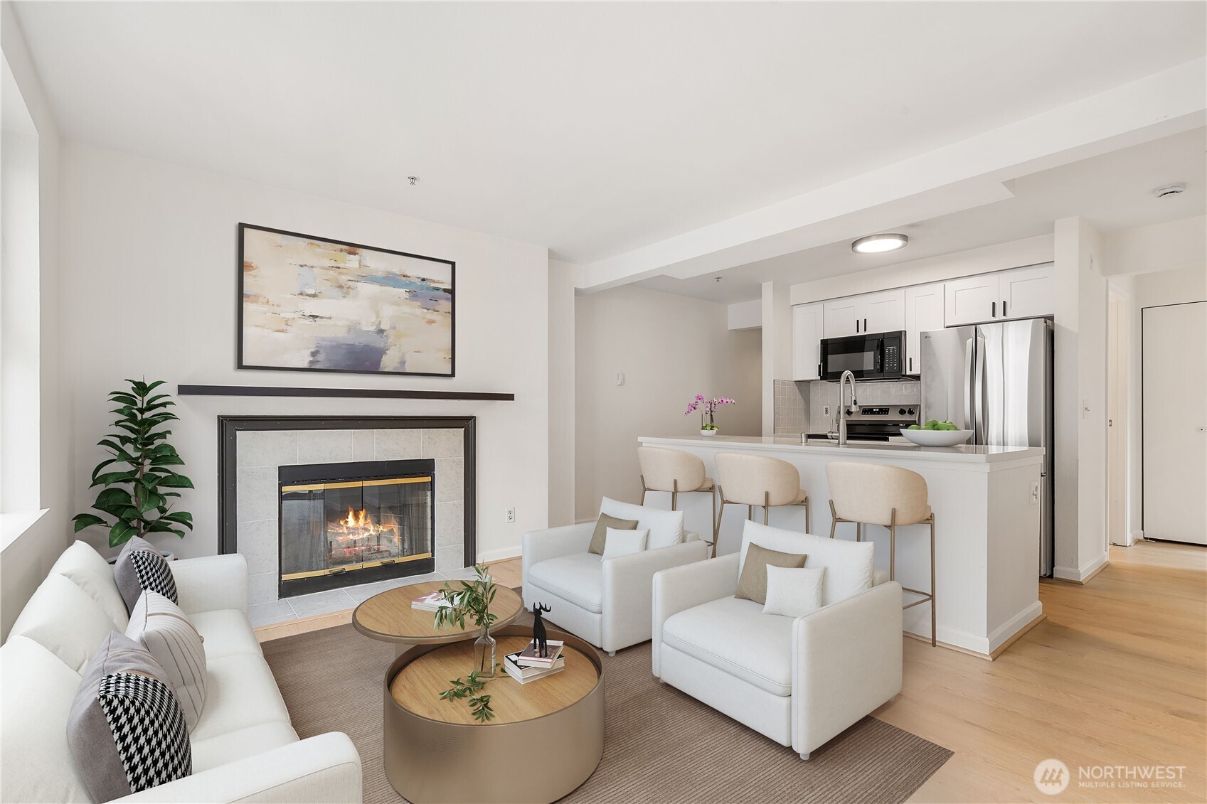 769 Hayes Street, Unit 405 Seattle, WA 98109 - Photo 2 of 29 a living room with furniture a fireplace and a kitchen view