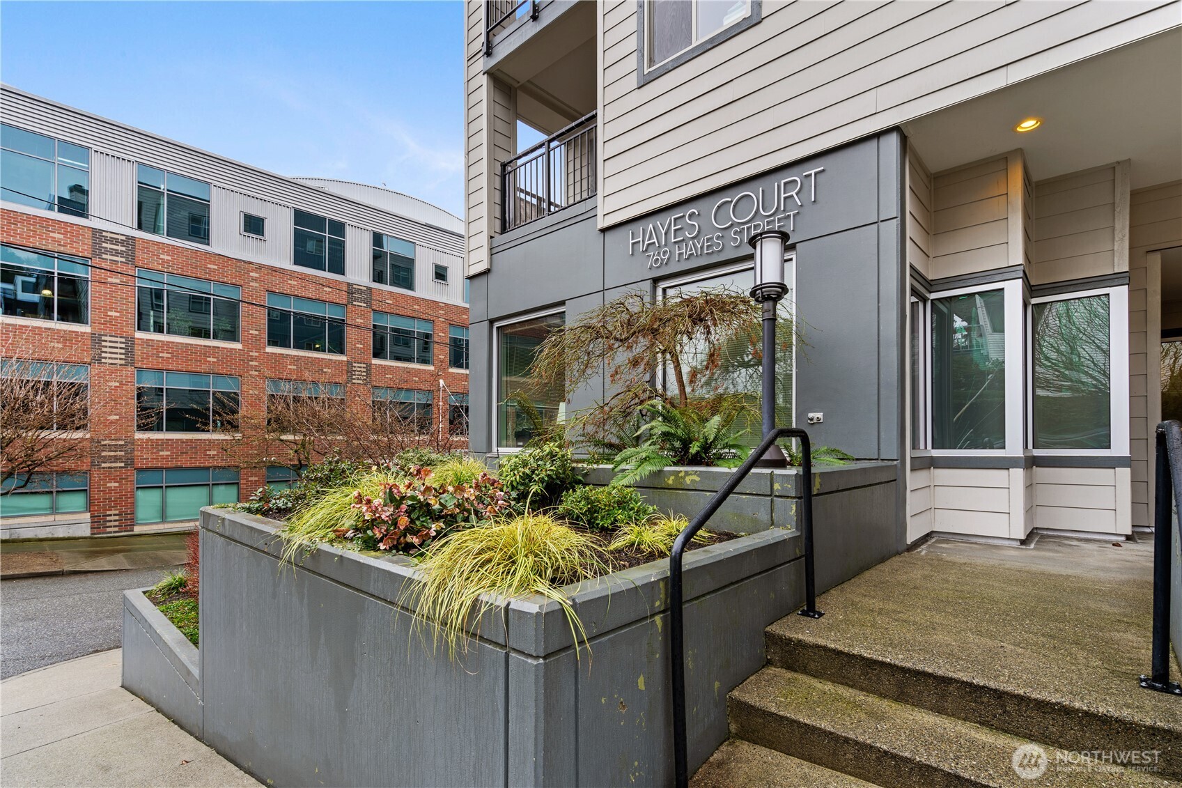 769 Hayes Street, Unit 405 Seattle, WA 98109 - Photo 25 of 29 a front view of a house with outdoor seating