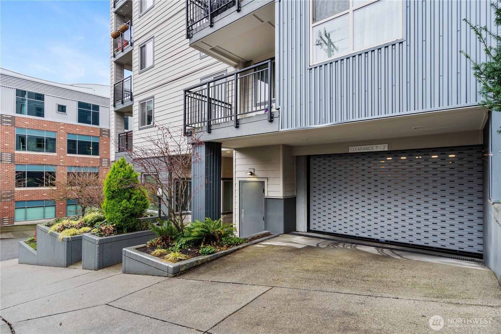 769 Hayes Street, Unit 405 Seattle, WA 98109 - Photo 26 of 29 a front view of a building with potted plants
