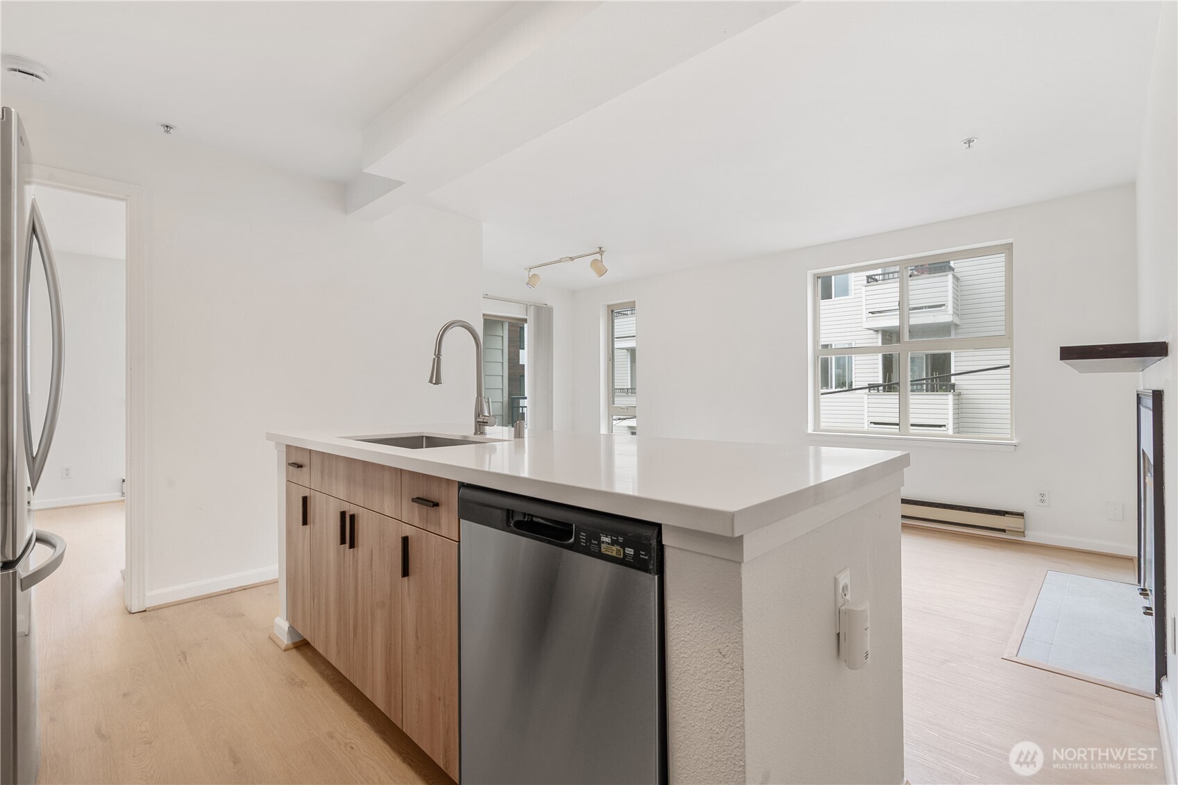 769 Hayes Street, Unit 405 Seattle, WA 98109 - Photo 6 of 29 a kitchen with stainless steel appliances a sink and a refrigerator