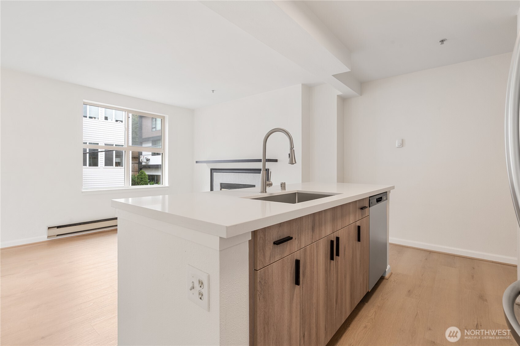 769 Hayes Street, Unit 405 Seattle, WA 98109 - Photo 10 of 29 a kitchen with stainless steel appliances a sink and a stove