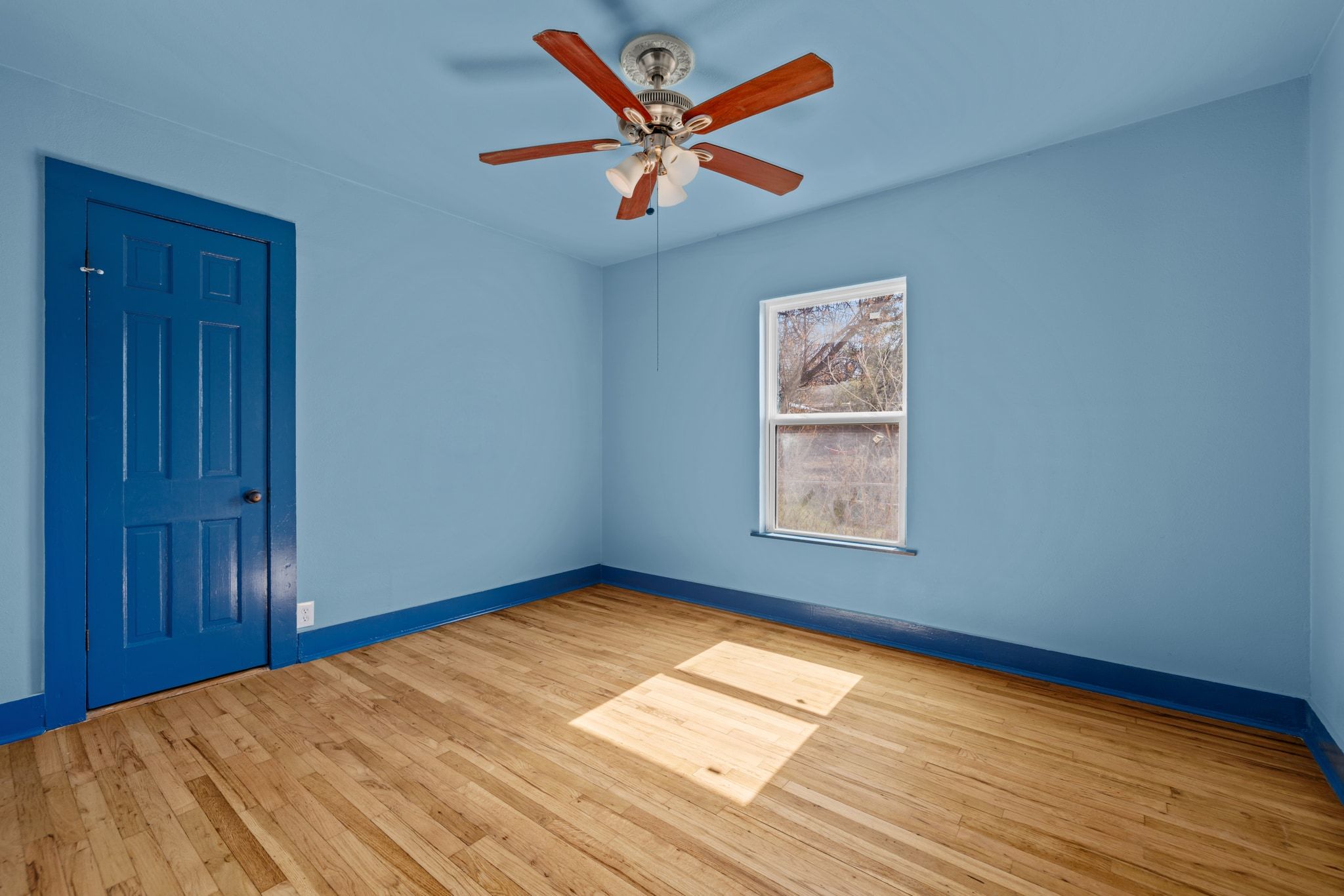 1181 Graham Street Austin, TX 78702 - Photo 19 of 27 a view of an empty room with window and wooden floor