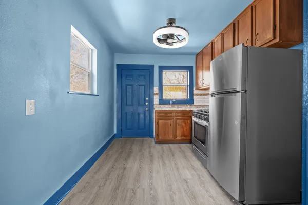 a kitchen with a refrigerator and a stove