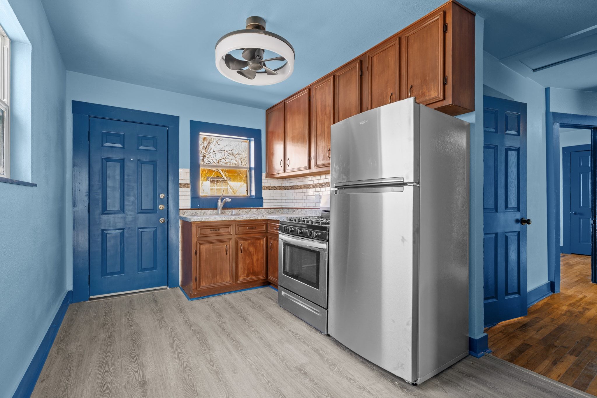 1181 Graham Street Austin, TX 78702 - Photo 9 of 27 a kitchen with a refrigerator and a stove top oven