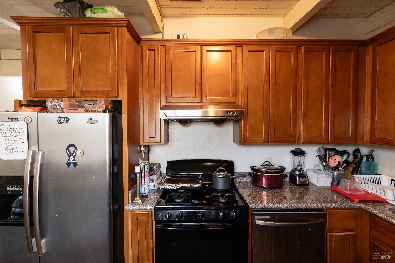 1500 Harrison Street Fairfield, CA 94533 - Photo 11 of 24 a kitchen with granite countertop a refrigerator stove and cabinets