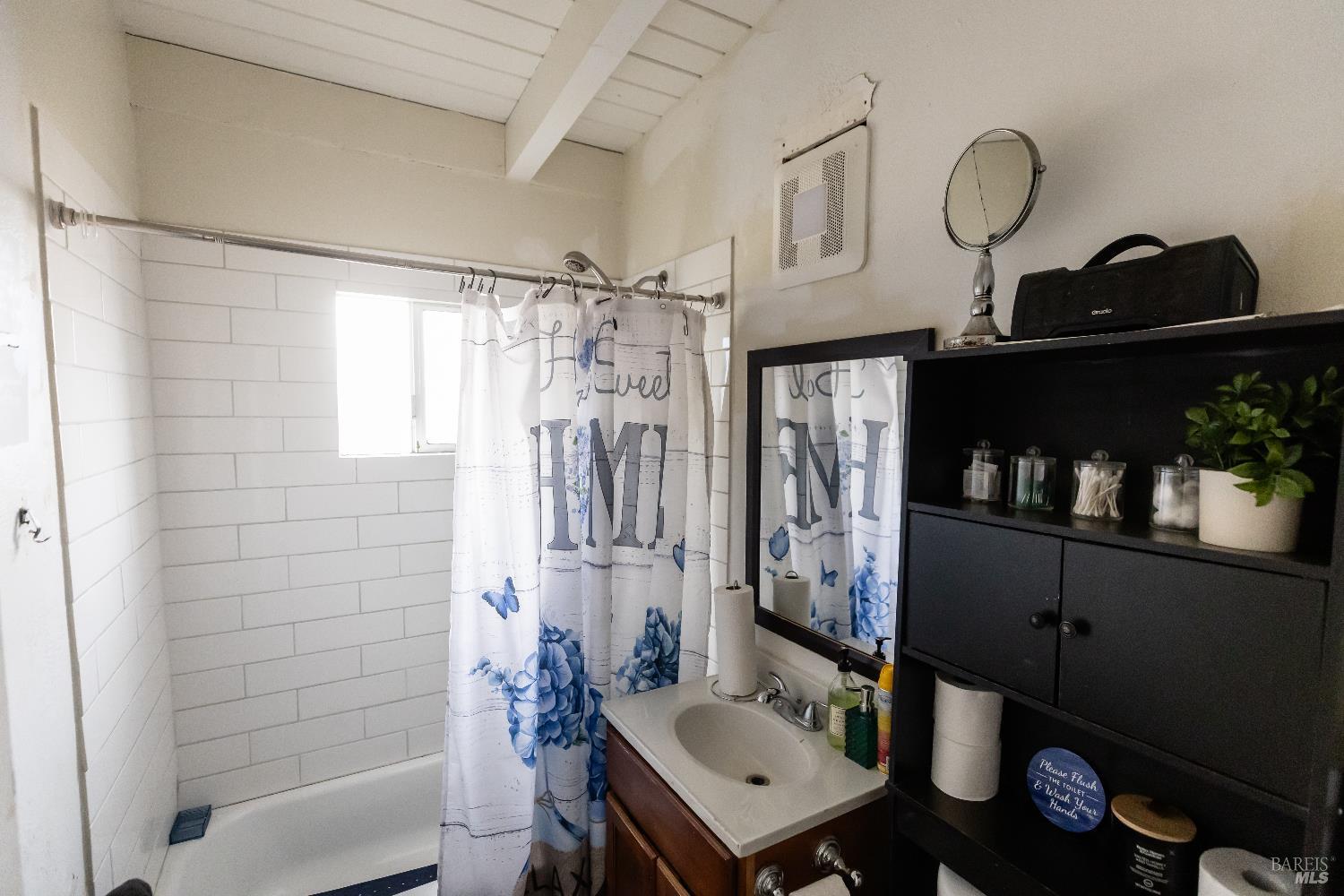 1500 Harrison Street Fairfield, CA 94533 - Photo 15 of 24 a bathroom with a sink a mirror and a shower