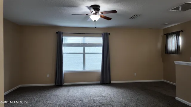 a view of room with ceiling fan