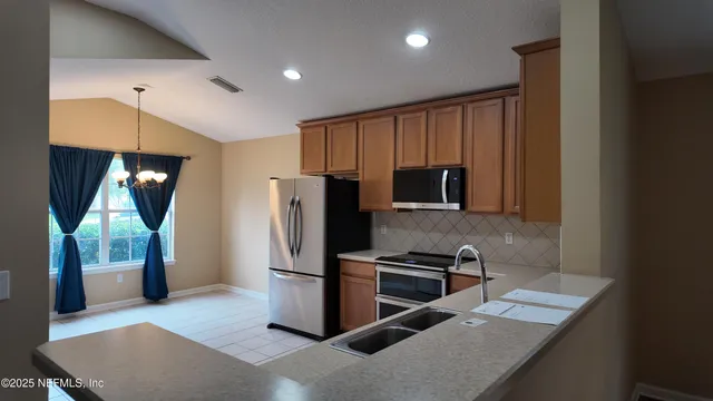 a kitchen with a refrigerator and a sink