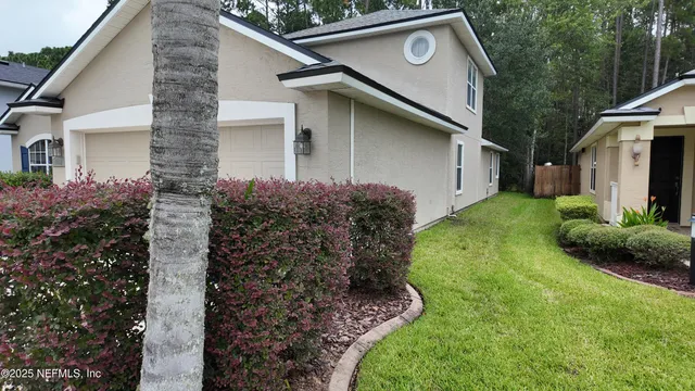 a view of a house with a yard and plants