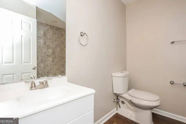 a bathroom with a sink toilet and a mirror