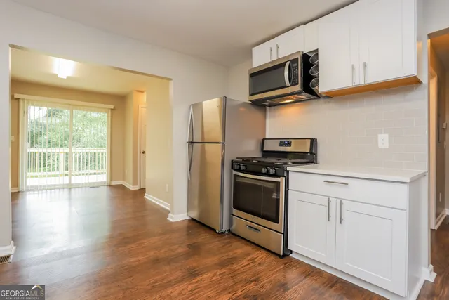 a kitchen with stainless steel appliances a stove microwave and a refrigerator