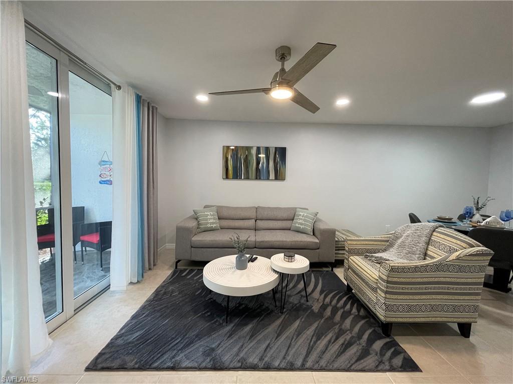 170 Turtle Lake Court, Unit 103 Naples, FL 34105 - Photo 3 of 37 Living area with light tile patterned floors, recessed lighting, expansive windows, and ceiling fan