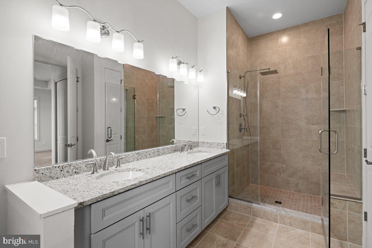 4 Samarpan Court Hightstown, NJ 08520 - Photo 14 of 39 a bathroom with a shower sink double and mirror