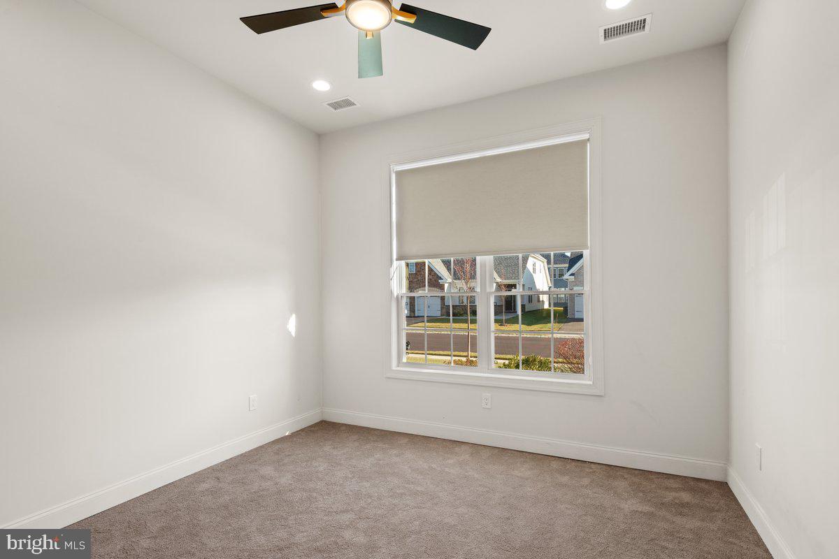 4 Samarpan Court Hightstown, NJ 08520 - Photo 17 of 39 an empty room with windows and chandelier fan