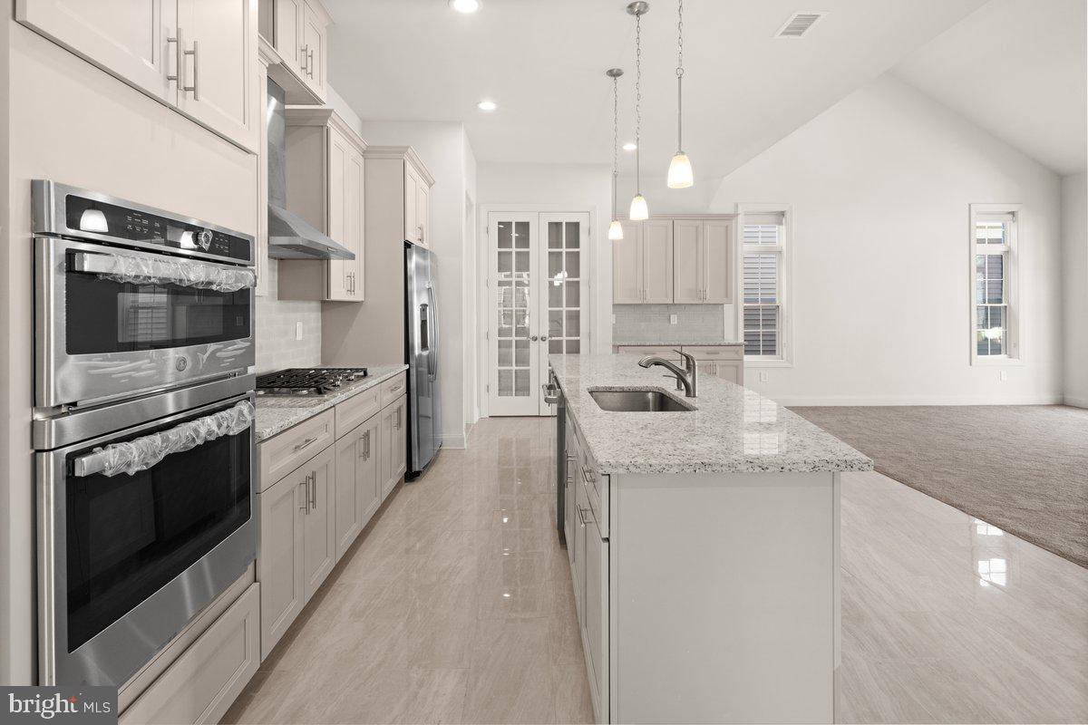4 Samarpan Court Hightstown, NJ 08520 - Photo 6 of 39 a kitchen with stainless steel appliances granite countertop a sink and a stove