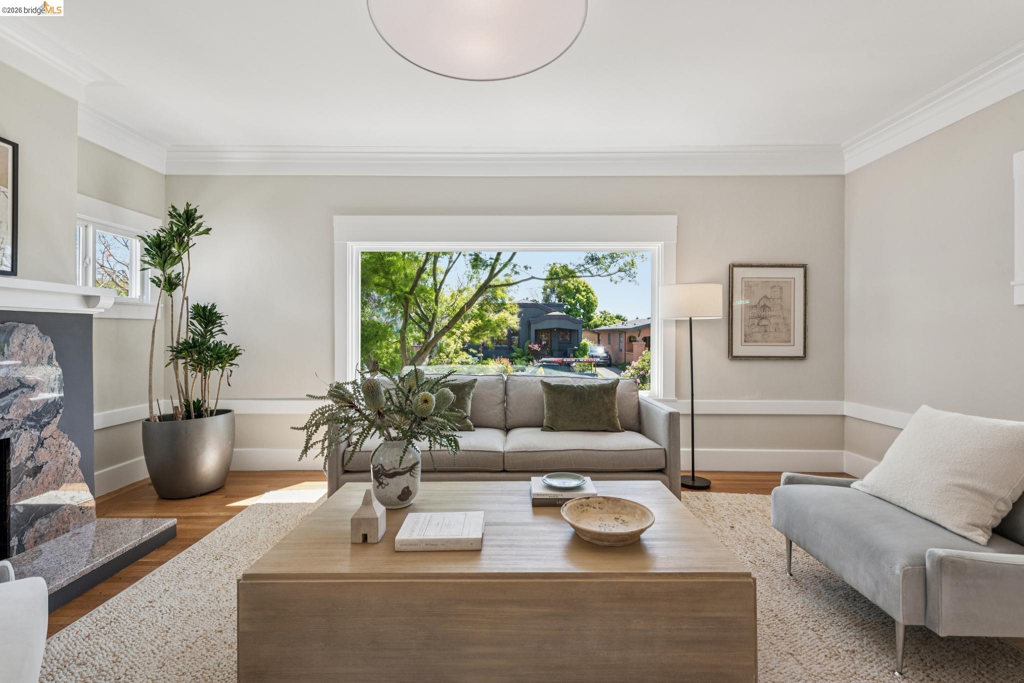 1233 Carleton Street Berkeley, CA 94702 - Photo 8 of 41 Living area featuring hardwood floors, a fireplace, and molding details