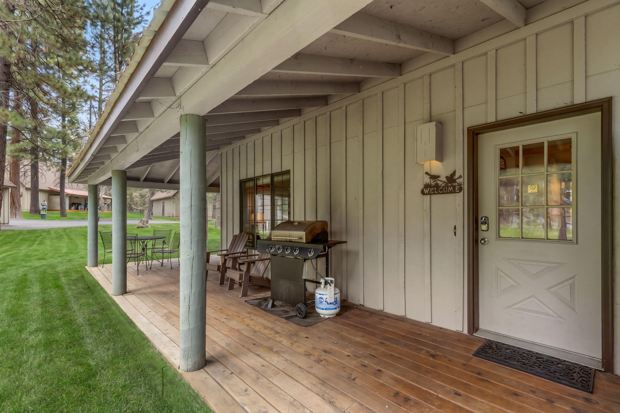 57505 Circle 4 Cabin Road, Unit 29 Sunriver, OR 97707 - Photo 7 of 35 a view of a porch with chairs and backyard