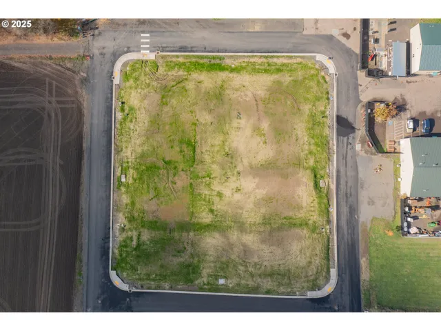 an aerial view of a residential houses with outdoor space