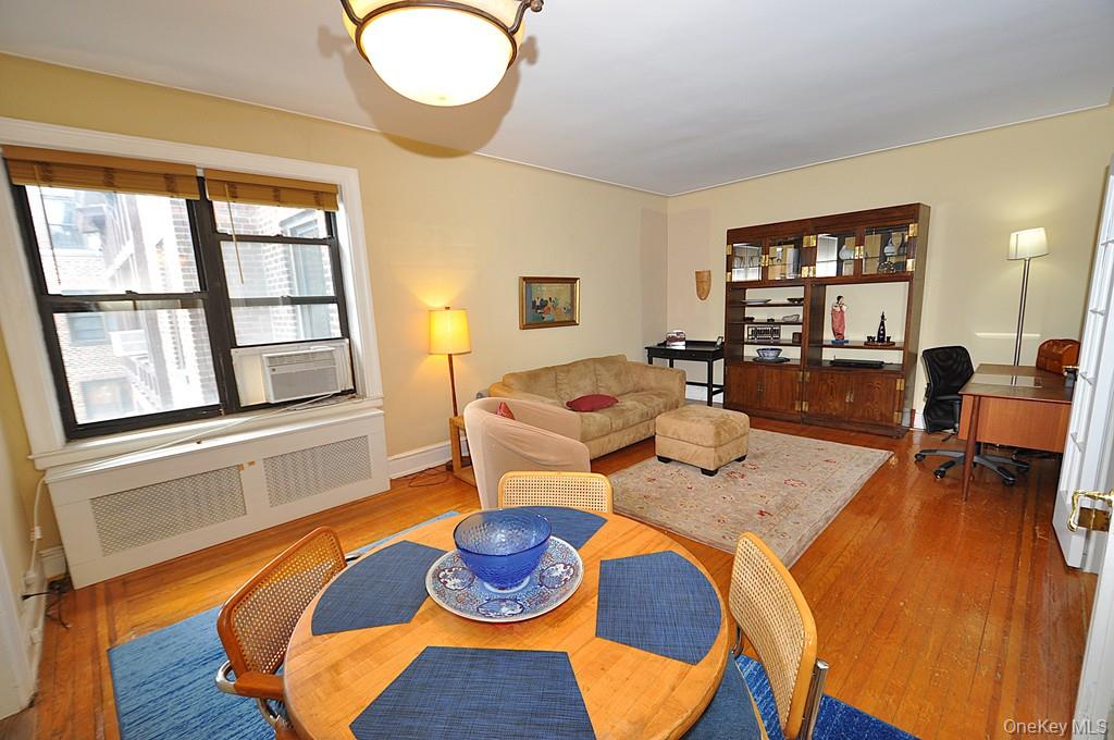 143 Garth Road, Unit 5J Scarsdale, NY 10583 - Photo 8 of 47 a living room with furniture and a large window