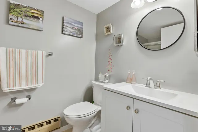 a bathroom with a toilet a sink and a mirror