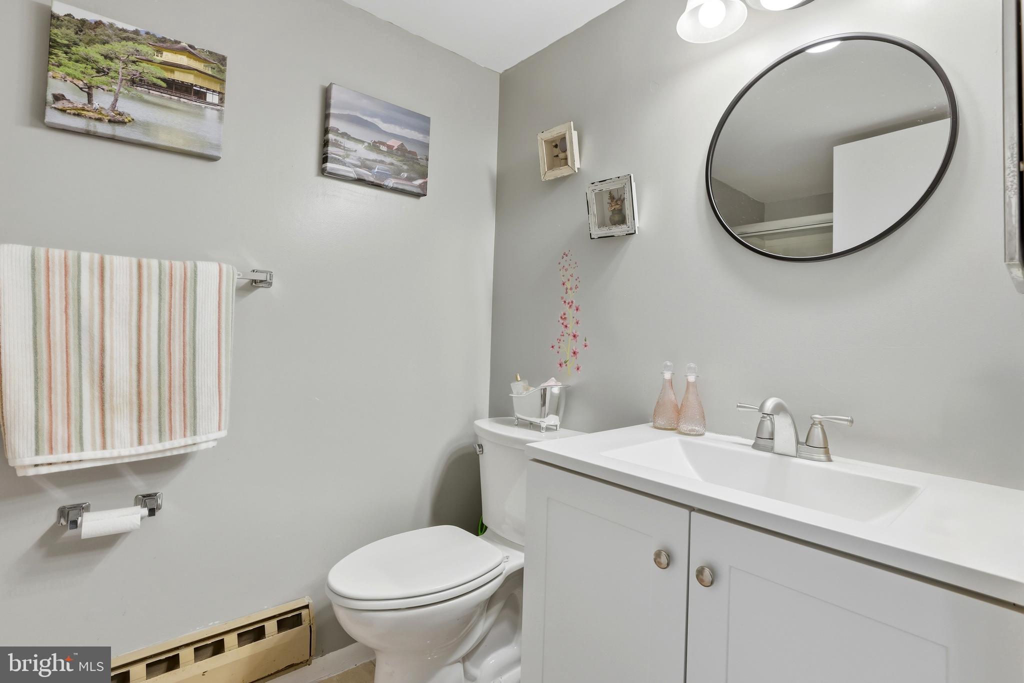 15300 Beaverbrook Court, Unit 882E Silver Spring, MD 20906 - Photo 17 of 30 a bathroom with a toilet a sink and a mirror