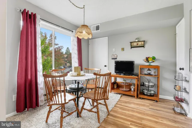 a view of a dining room with furniture window and wooden floor