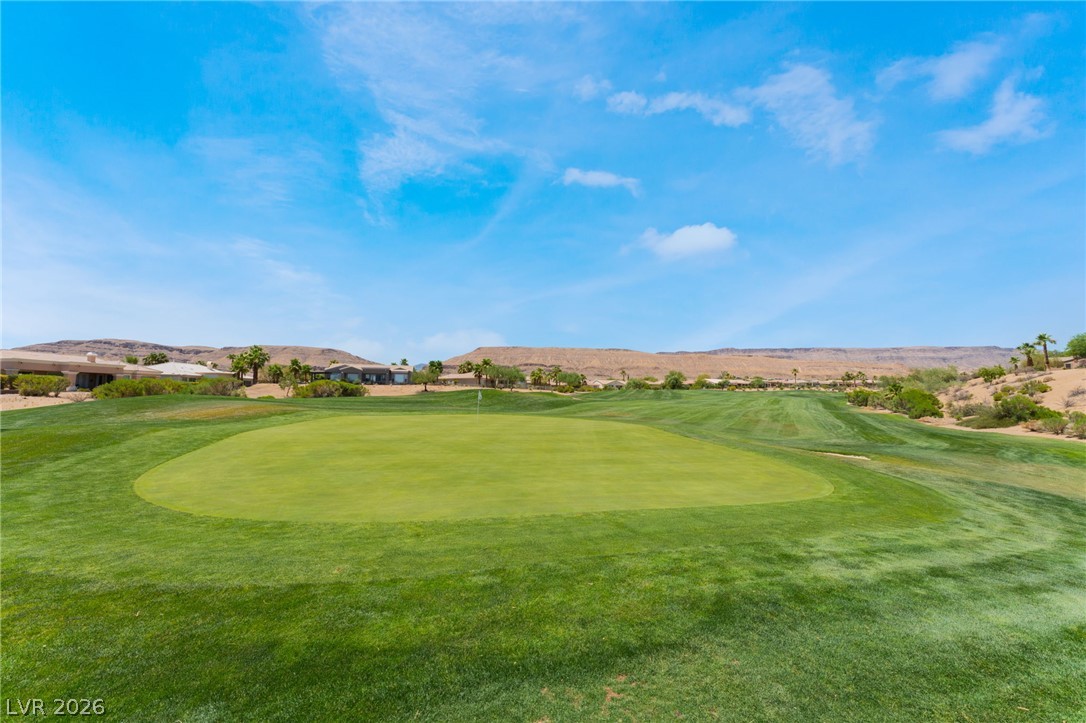 5389 Progresso Street Las Vegas, NV 89135 - Photo 34 of 41 Green fairways and manicured putting surfaces frame this pristine golf course with distant desert hills.