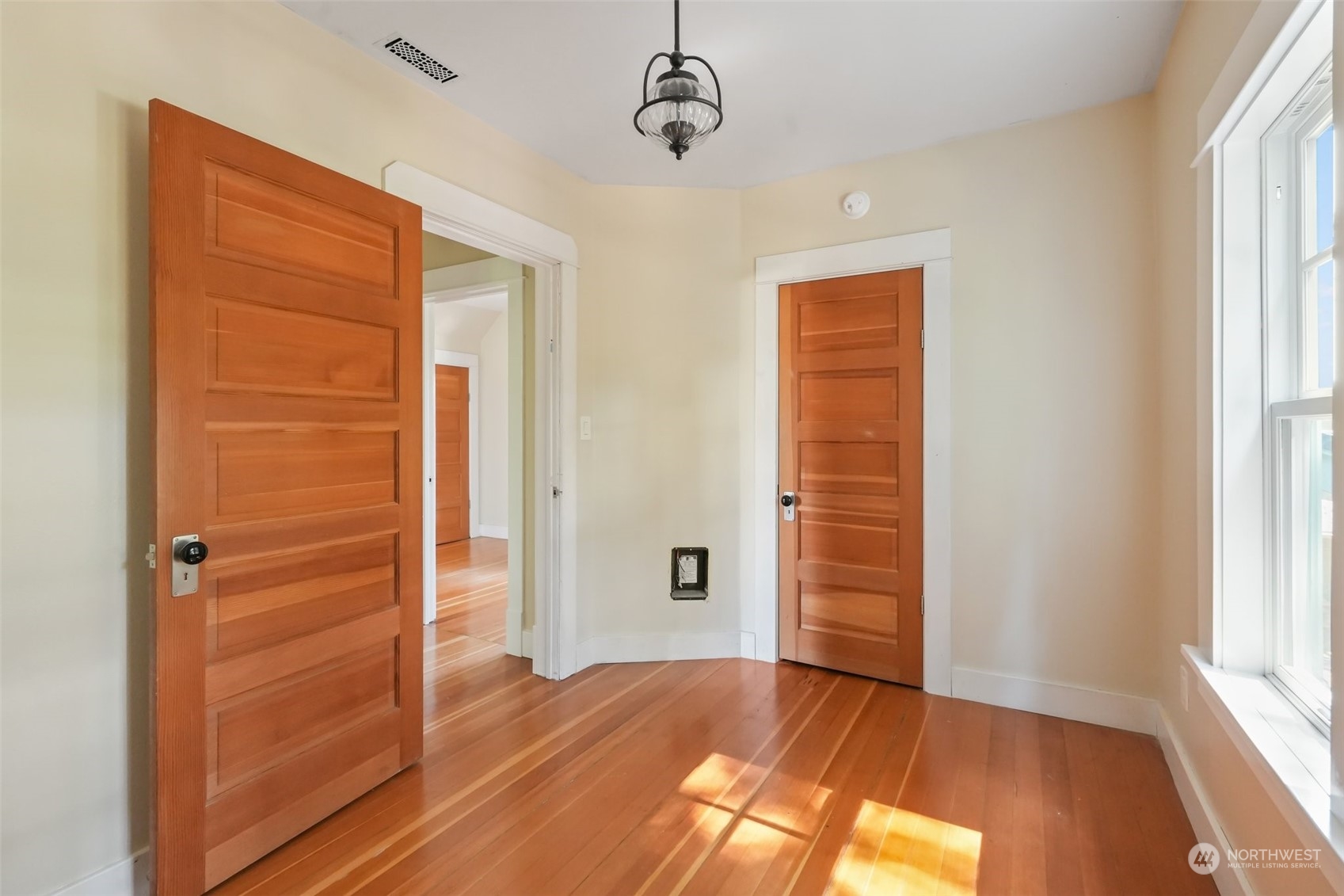 1702 North Pine Street Tacoma, WA 98406 - Photo 22 of 27 a view of an empty room with wooden floor and a window