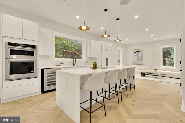 a spacious bathroom with a double vanity sink a mirror and a bathtub