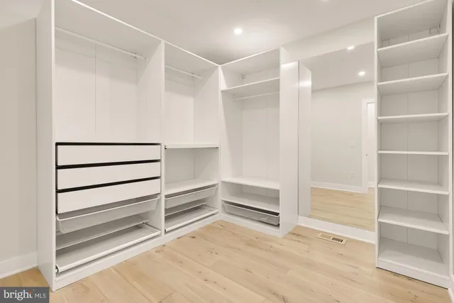 a view of a room with furniture and wooden floor