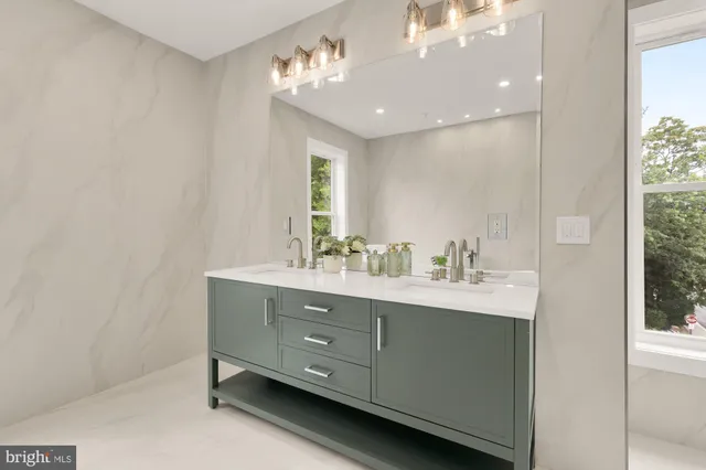 a living room with furniture and a refrigerator