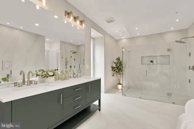 a living room with furniture and a refrigerator