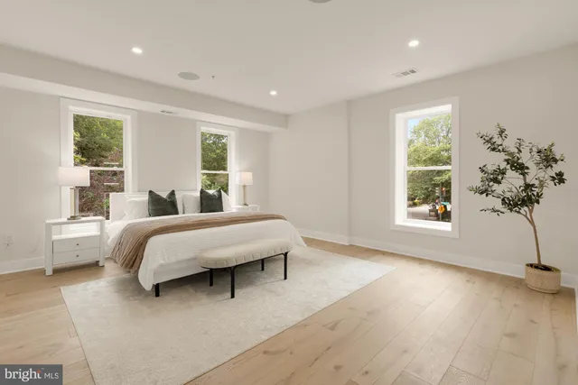 a kitchen with white cabinets and refrigerator
