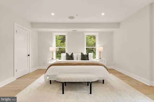 a bathroom with a shower sink vanity mirror and toilet