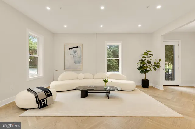 a view of kitchen with kitchen island stainless steel appliances refrigerator stove dining table and chairs