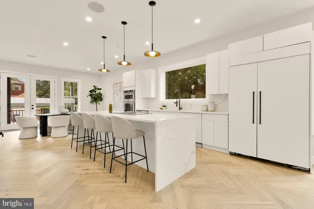 a large white kitchen with a large window