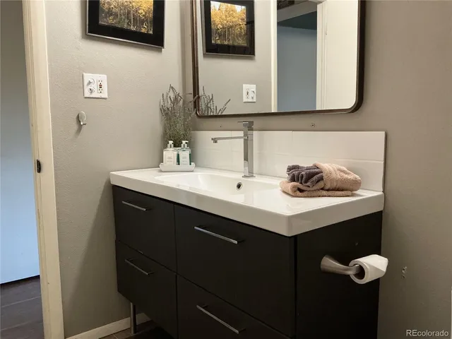 a bathroom with a sink and a mirror