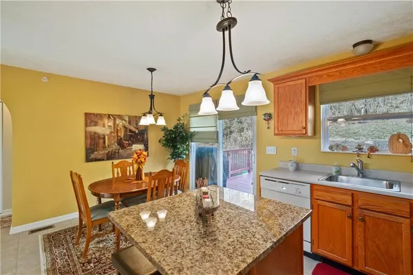 a dining table chairs and a chandelier