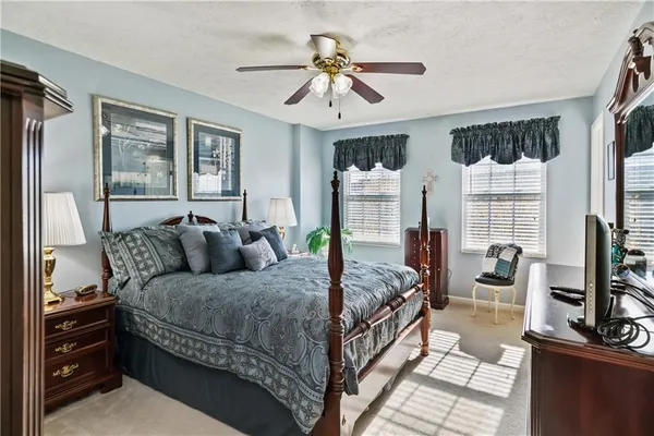 a bedroom with a balcony a bed and a chandelier