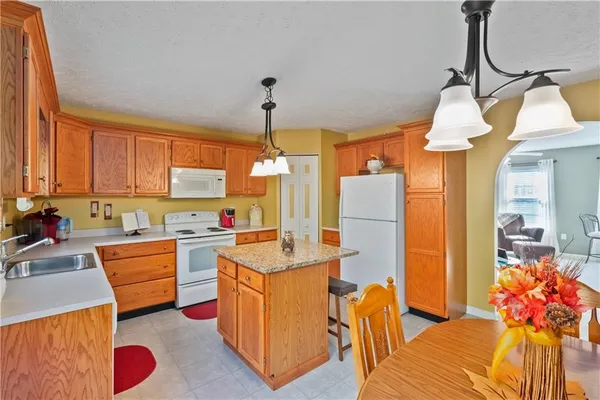 a very nice looking room with a dining table wooden floor and a chandelier