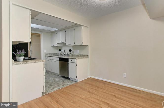 11625 Stoneview Square, Unit 2B Reston, VA 20191 - Photo 12 of 21 a kitchen with a sink cabinets and wooden floor