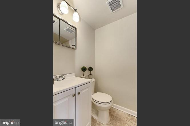 11625 Stoneview Square, Unit 2B Reston, VA 20191 - Photo 15 of 21 a bathroom with a toilet a sink and mirror