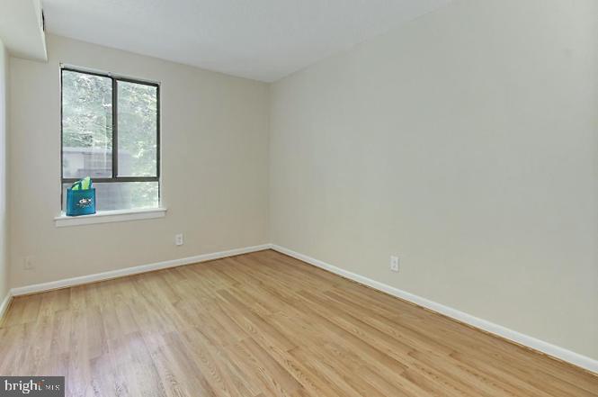 11625 Stoneview Square, Unit 2B Reston, VA 20191 - Photo 17 of 21 an empty room with wooden floor and windows