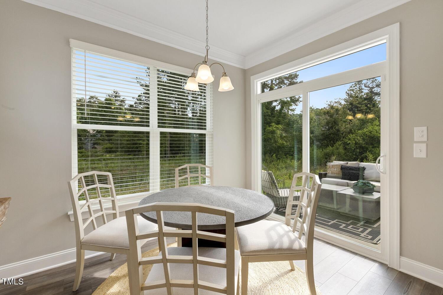 3455 Piedmont Drive Raleigh, NC 27604 - Photo 18 of 47 a view of a dining room with furniture large windows and wooden floor