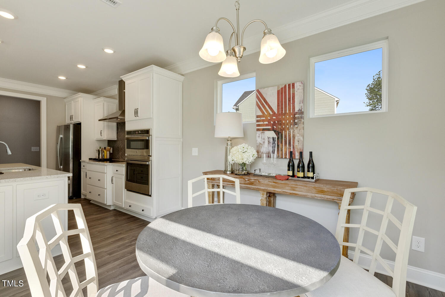 3455 Piedmont Drive Raleigh, NC 27604 - Photo 20 of 47 a kitchen with stainless steel appliances kitchen island granite countertop a table chairs and a refrigerator