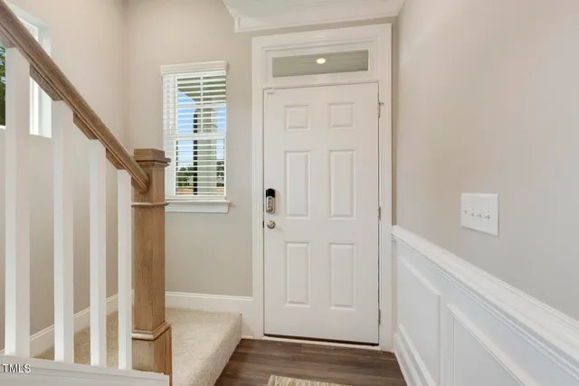 a bathroom with a granite countertop toilet a sink and mirror