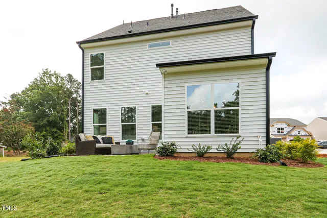 a front view of house with yard and outdoor seating