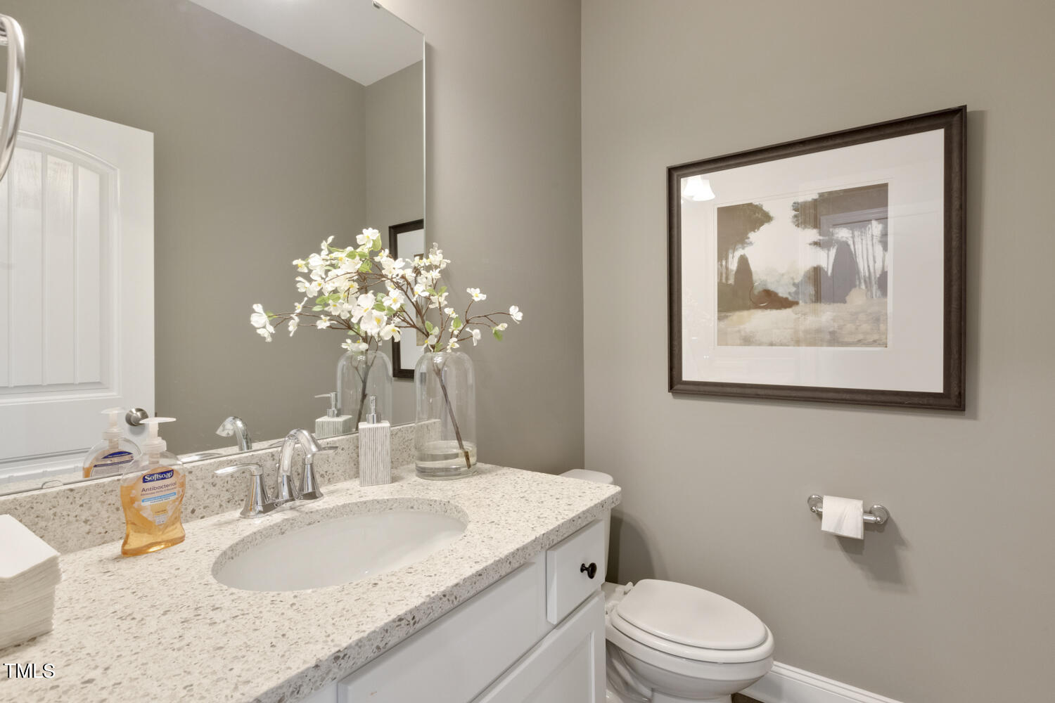 3455 Piedmont Drive Raleigh, NC 27604 - Photo 5 of 47 a bathroom with a granite countertop toilet a sink and mirror