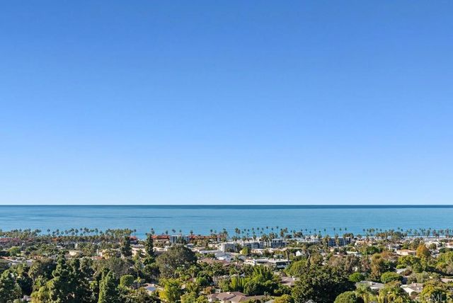 a hallway with wooden floor fireplace and living room