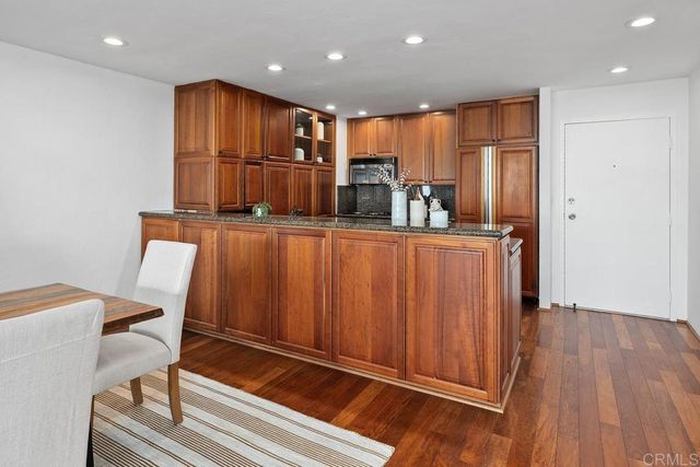 a kitchen with stainless steel appliances granite countertop a refrigerator and a sink